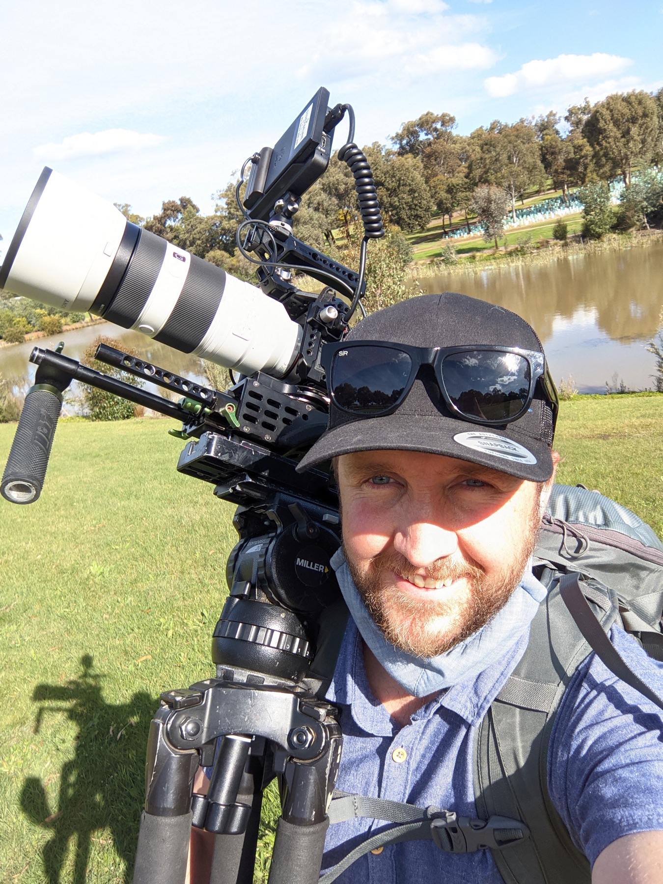 On location with a camera beside a waterway